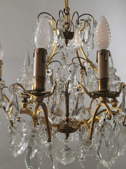 null Chandelier in gilded metal and crystal pendants with eight arms of light. With...