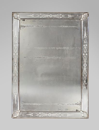 null Rectangular Venetian mirror with engraved feathers and flowers decoration. 

End...