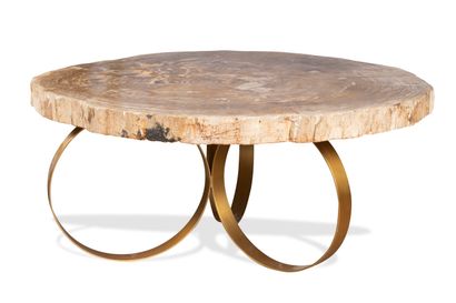 null Circular coffee table, the top in fossilized wood resting on a gilded metal...