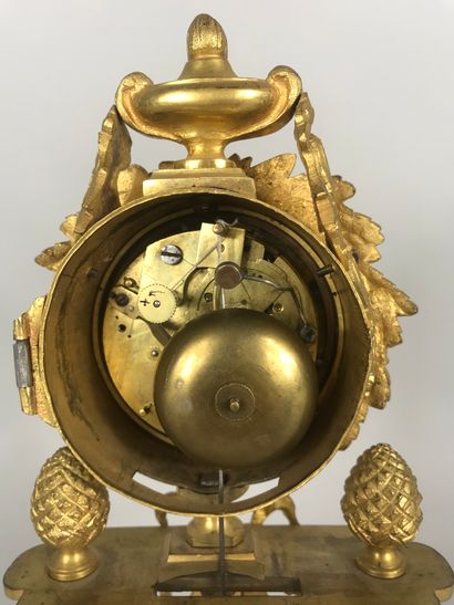 null 
Clock in gilt bronze, the dial inscribed in a frieze of laurels and topped...