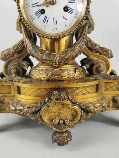 null Chased gilt bronze clock decorated with laurel garlands, scrolls, and friezes...