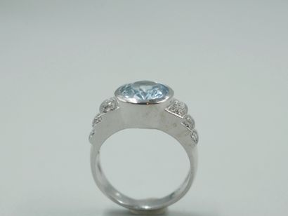 null 18k white gold band ring centered with an oval aquamarine of about 3cts in a...