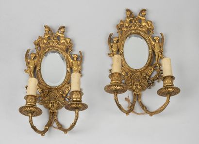 null Pair of gilt metal sconces with reflectors with two arms of light decorated...