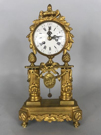 null 
Clock in gilt bronze, the dial inscribed in a frieze of laurels and topped...