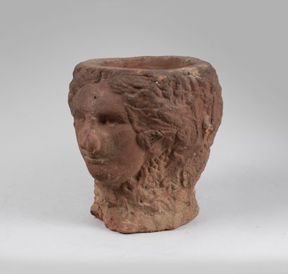 null Urn in red clay decorated with Janus carved in the round in the antique style....