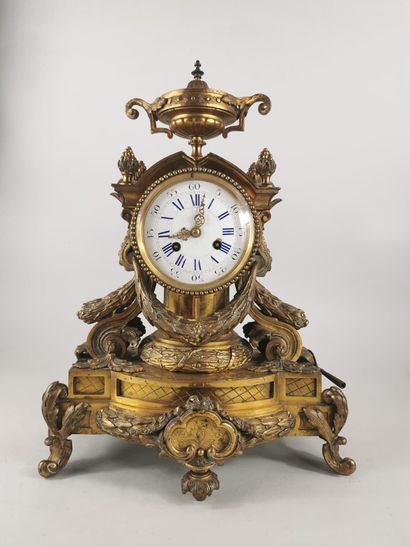 null Chased gilt bronze clock decorated with laurel garlands, scrolls, and friezes...