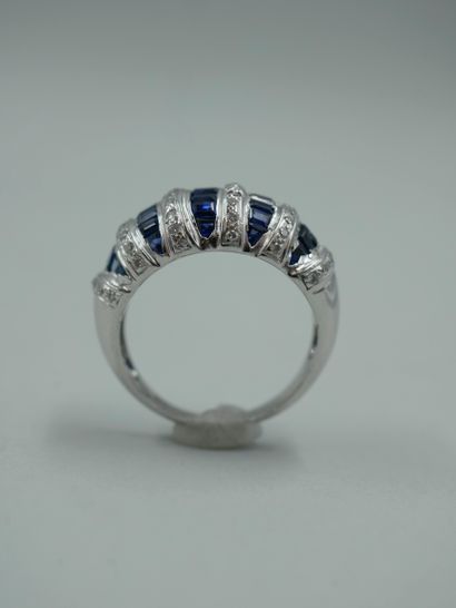 null 18K white gold dome ring set with lines of calibrated sapphires alternating...