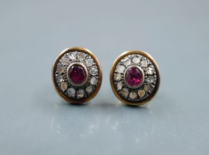 null A pair of 18k yellow gold and silver medallion earrings with a 1ct oval ruby...