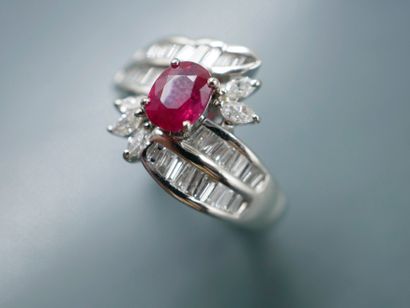 null 
A platinum ring set with a 1ct oval ruby surrounded by two lines of baguette-cut...