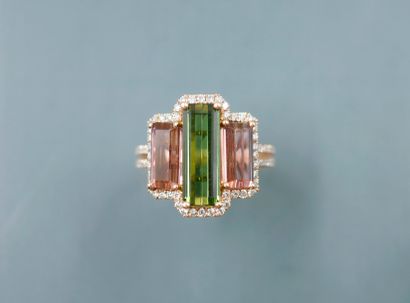 null 18k rose gold ring set with a rectangular green tourmaline flanked by two rectangular...