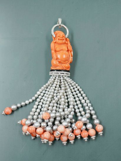 null Pendant adorned with a standing coral Buddha, haloed by a line of diamonds openwork...