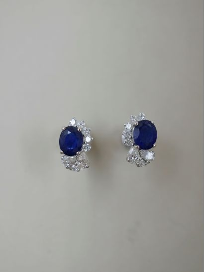 null Pair of 18k white gold earrings set with a sapphire weighing approximately 0.80cts...
