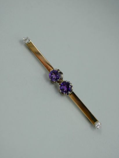 null Brooch in 18k yellow gold and platinum set with two amethysts and a diamond...
