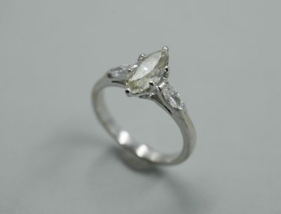 null 18k white gold ring set with a 1 ct. navette diamond and two navette diamonds....