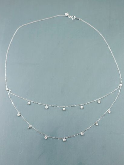 null Necklace in 18k white gold adorned with two rows of chains of brilliant-cut...