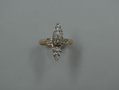 null Marquise ring in 18k yellow gold and platinum, centered on a round diamond of...