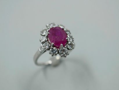 null Platinum flower ring set with a ruby weighing approximately 2.50 cts in a diamond...