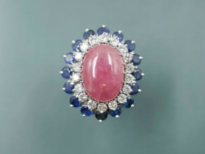 null 14k white gold pompadour ring set with a ruby cabochon surrounded by a line...