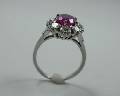 null Platinum flower ring set with a ruby weighing approximately 2.50 cts in a diamond...