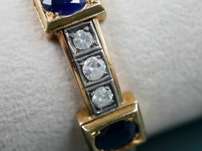 null 18k yellow gold and silver bracelet topped with three oval sapphires alternating...