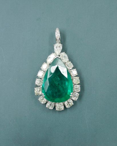 null Important 18k white gold drop pendant set with a 14 ct pear cut emerald surrounded...