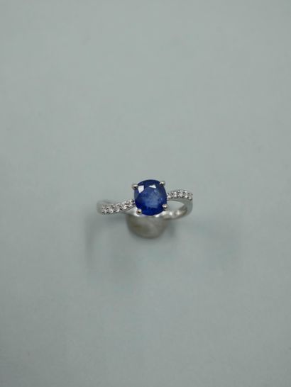null 18K white gold ring set with an oval sapphire weighing 1.20cts, the setting...