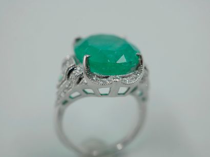 null Platinum ring set with a large oval Colombian emerald of about 10 cts., set...