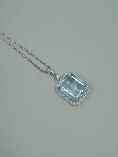 null 18k white gold pendant set with an emerald-cut aquamarine weighing approximately...