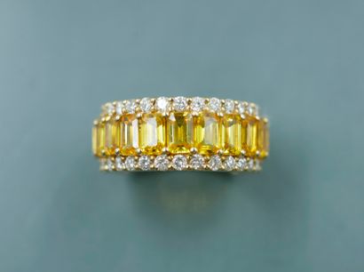 null 18k yellow gold band ring set with a line of rectangular yellow sapphires for...