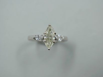 null 18k white gold ring set with a 1 ct. navette diamond and two navette diamonds....
