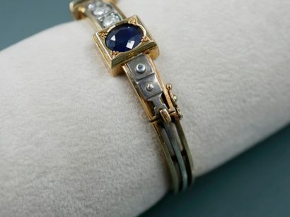 null 18k yellow gold and silver bracelet topped with three oval sapphires alternating...