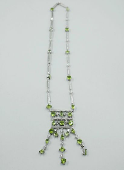 null 18k white gold drapery necklace set with lines of diamonds in bars holding peridots...