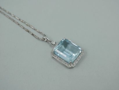 null 18k white gold pendant set with an emerald-cut aquamarine weighing approximately...