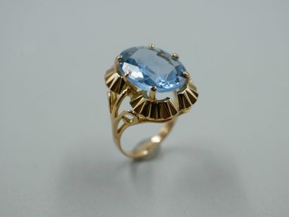 null Ring in 18k yellow gold set with an oval topaz of about 6cts in a collared setting....