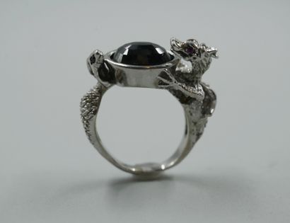 null 18k white gold ring set with a central faceted black diamond surrounded by two...