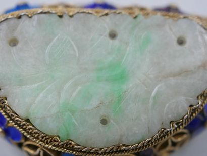 null A vermeil brooch decorated with a jade plate carved with flowers in an openwork...