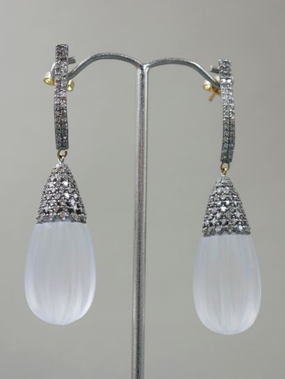 null 
Pair of 14k yellow gold and silver earrings holding a cut crystal pearl with...