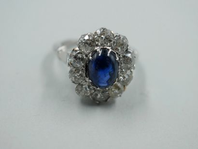null 18k white gold Pompadour ring set with an oval sapphire cabochon weighing approximately...