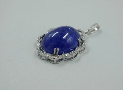 null 18k white gold pendant with a 25cts tanzanite cabochon in a polylobate diamond...