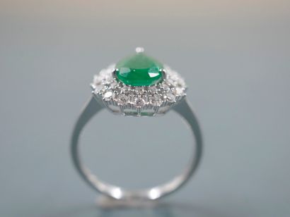 null 18k white gold ring set with a pear-shaped bezel and a pear-cut emerald in a...