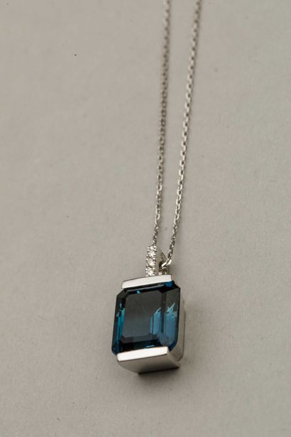 null Pendant Design in 18k white gold topped with an emerald-cut London Blue topaz...