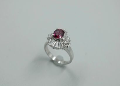 null 
Platinum skirt ring set with an oval ruby and marquise-cut diamonds in a double...