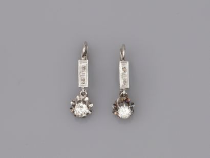 null 18k white gold and platinum sleeper earrings, each set with a 0.25ct diamond...