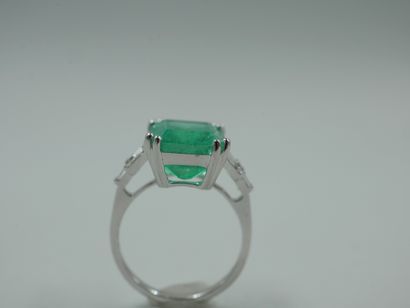 null Art Deco style ring in 18k white gold set with a large emerald cut emerald of...