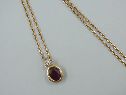 null 18k yellow gold pendant with an oval ruby of 2.6cts approximately, topped by...