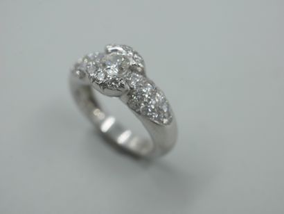 null 18k white gold ring centered with a brilliant-cut diamond in a pavé diamond...