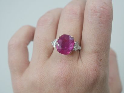 null 18k white gold ring set with a large oval ruby in a claw setting weighing approximately...