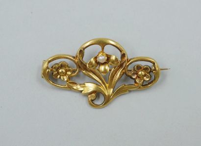 null 18k yellow gold arabesque brooch with foliage and flowers centered on a small...
