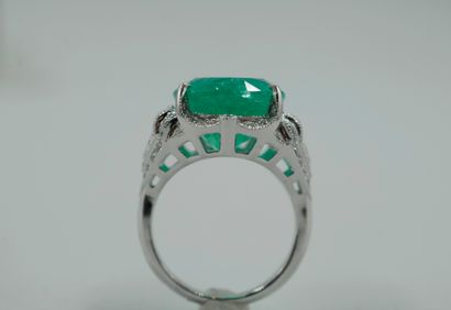null 
Platinum ring set with a large oval Colombian emerald weighing approximately...