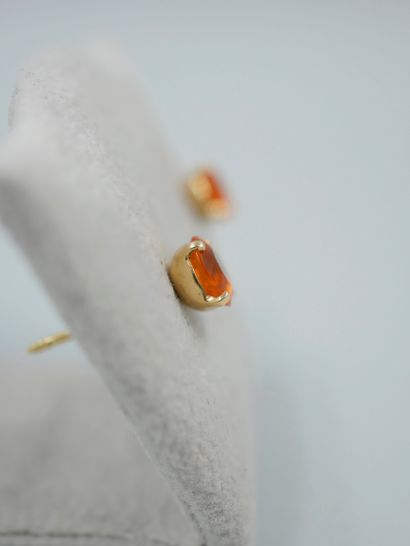 null Pair of 18K yellow gold earrings set with a round faceted fire opal.

Dimensions...
